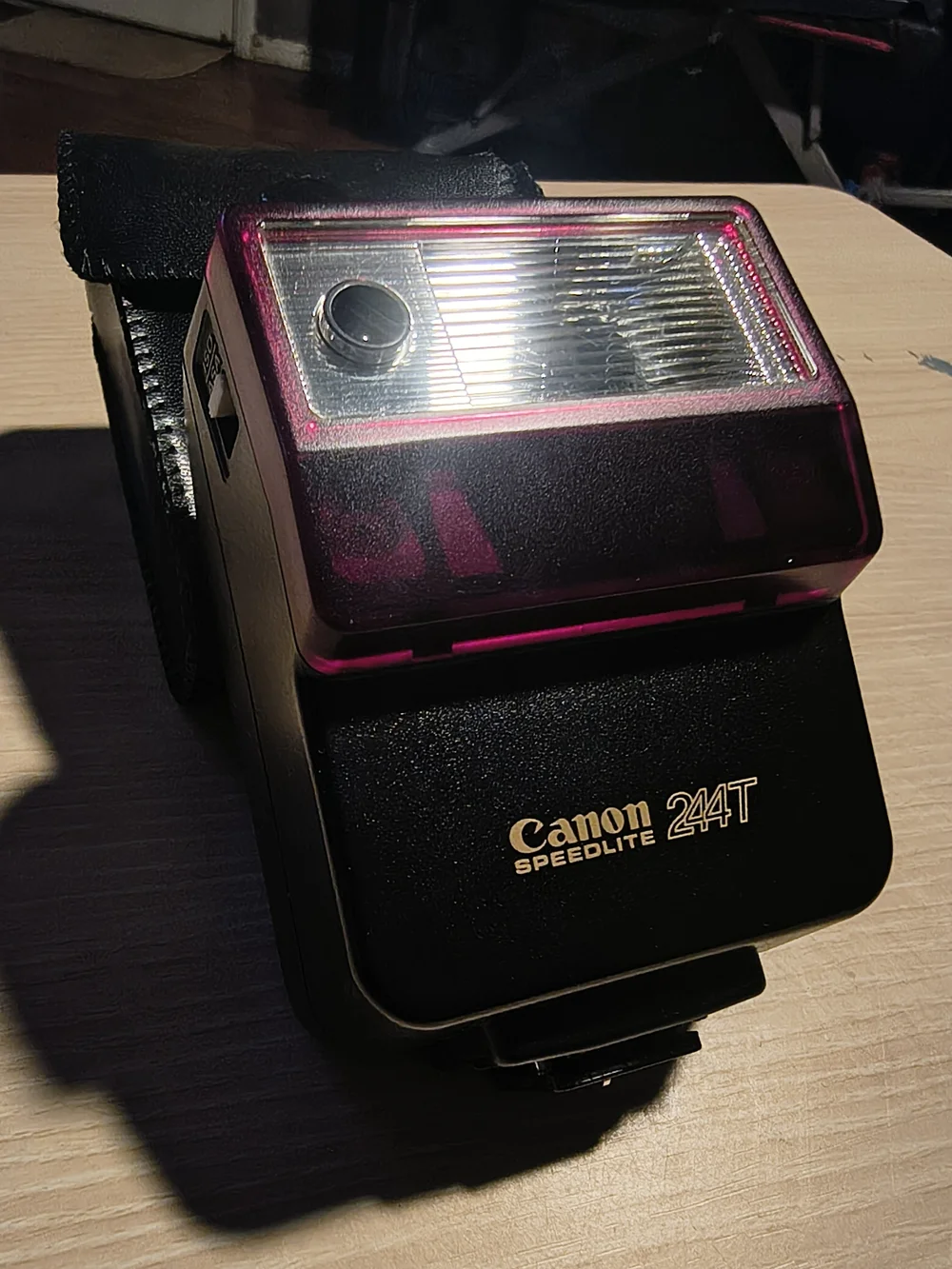 vintage Canon Speedlite 244T electronic flash unit with its leather case,